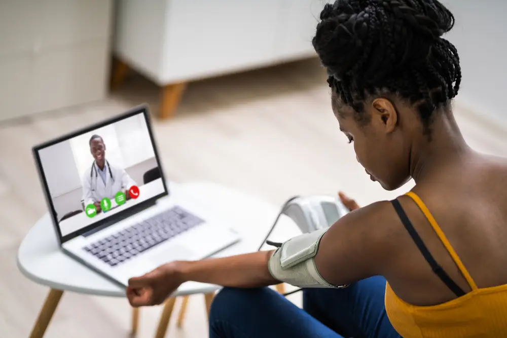 Online Videoconference On Laptop With African Doctor
